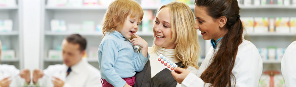 pharmacist giving vitamins to child